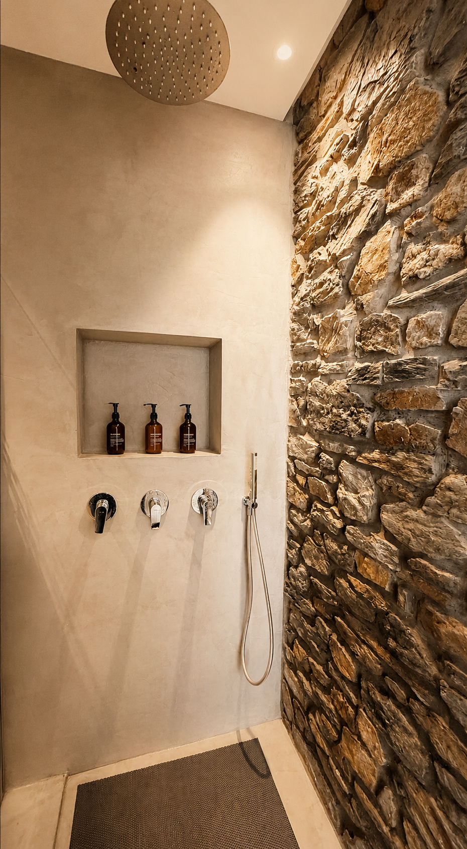 Full spa-like bathroom with stone walls in the Nyx residence