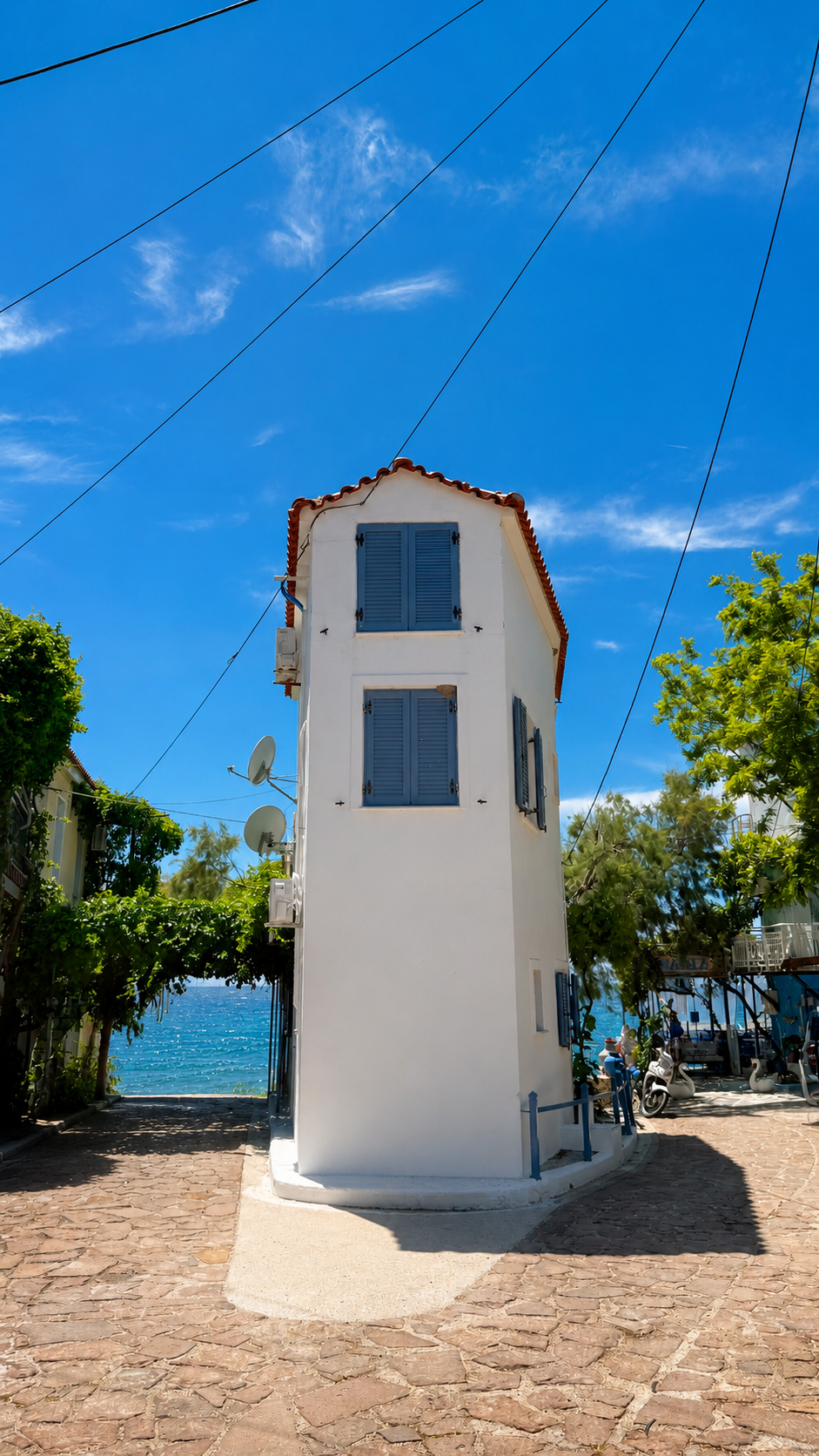 A whitewashed corner house by the sea