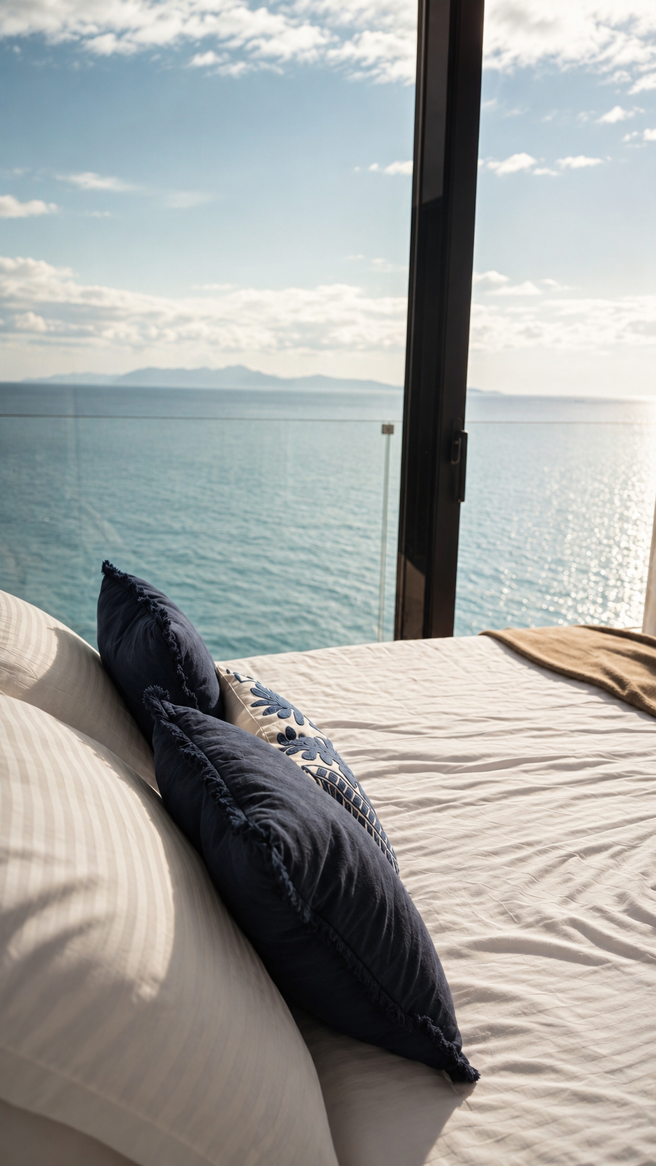 Bedroom with linen bed and open sea view