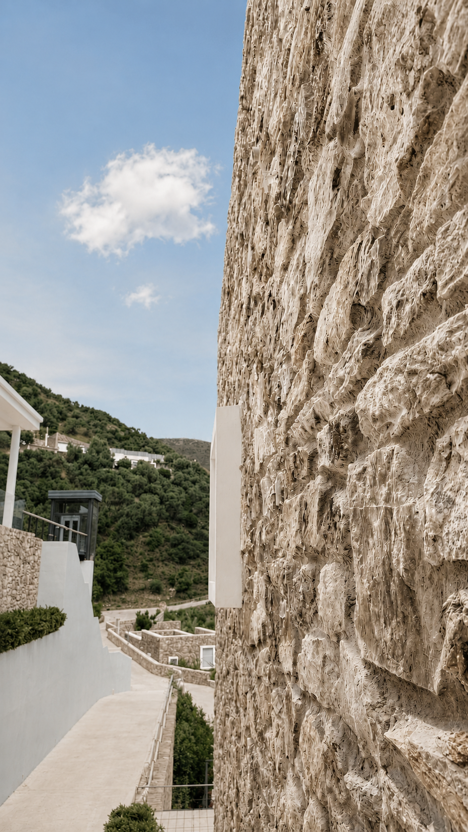 Stone wall, hillside and sea beyond