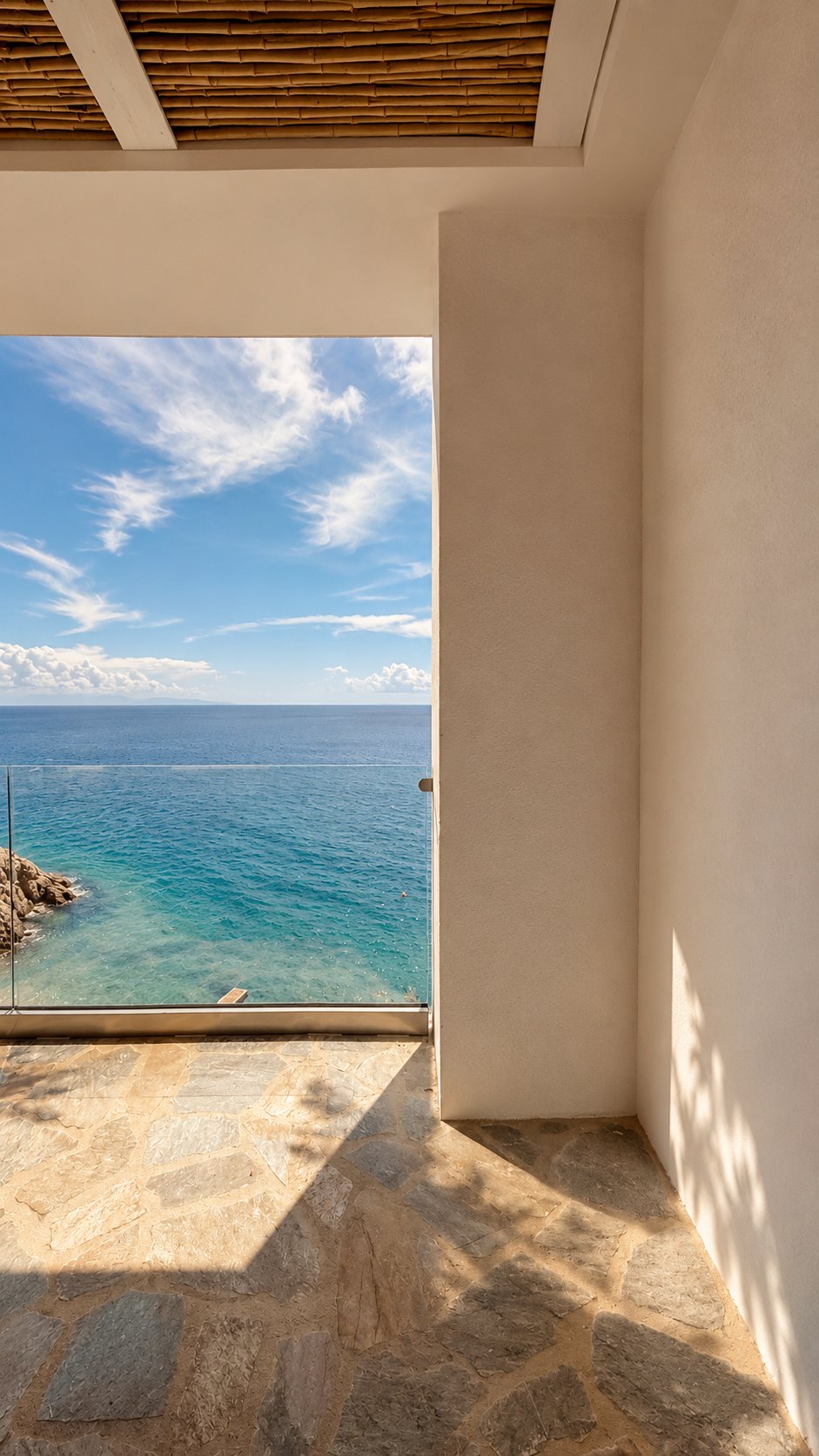 Stone terrace opening wide to the Aegean