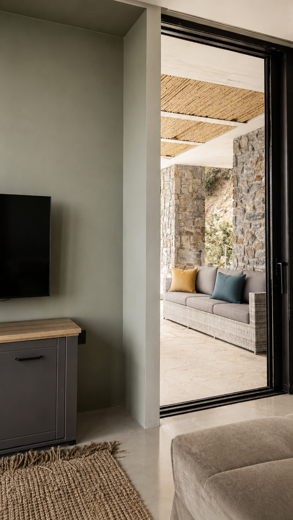 Living area with media wall opening to the terrace
