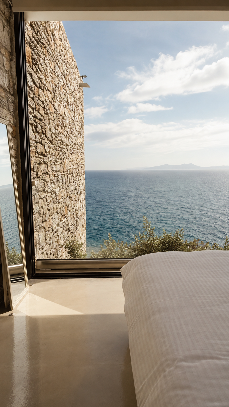 Linen and morning light over the water in the Nyx bedroom