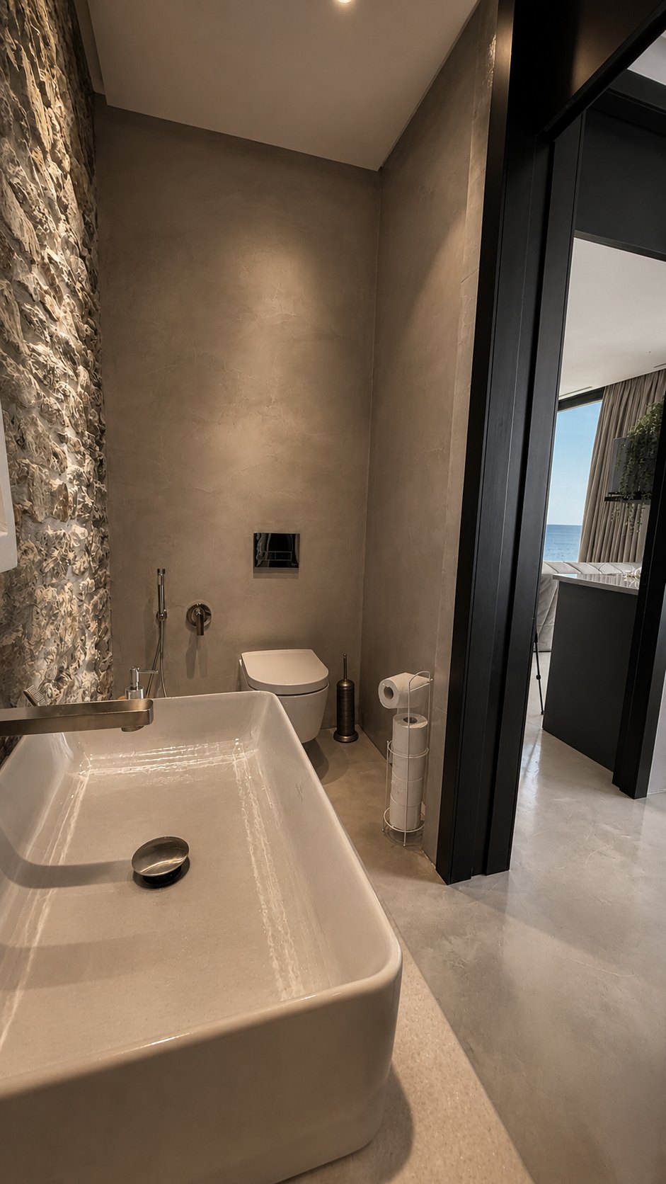 Stone basin and vanity opening to the sea