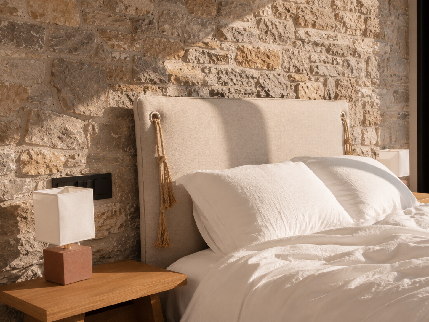 Selene Suite bed against a stone wall