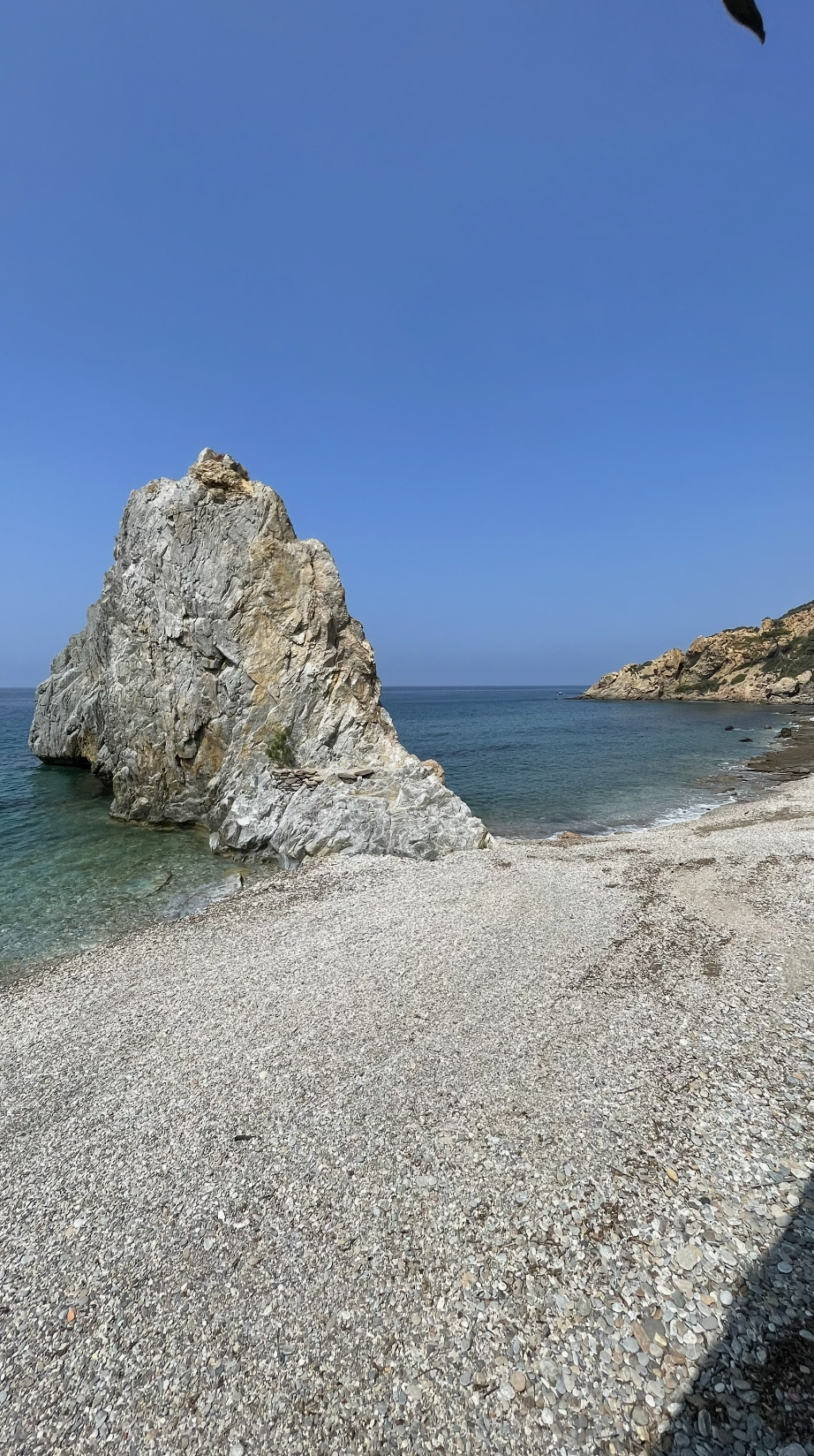 A white rock standing in the sea