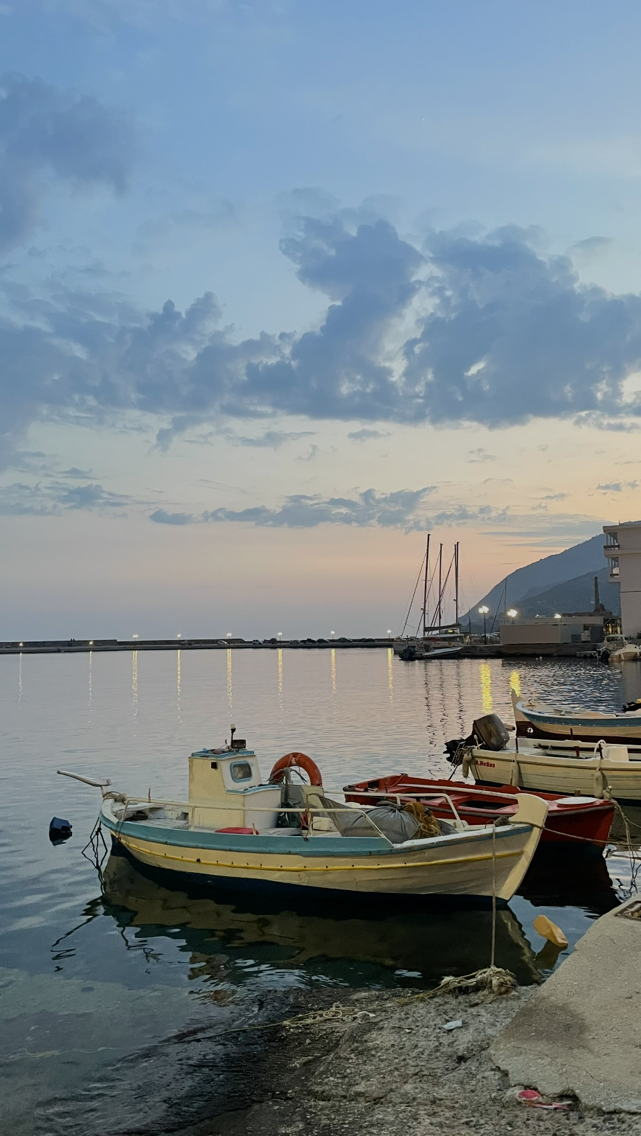 Harbor at dusk, small boats moored