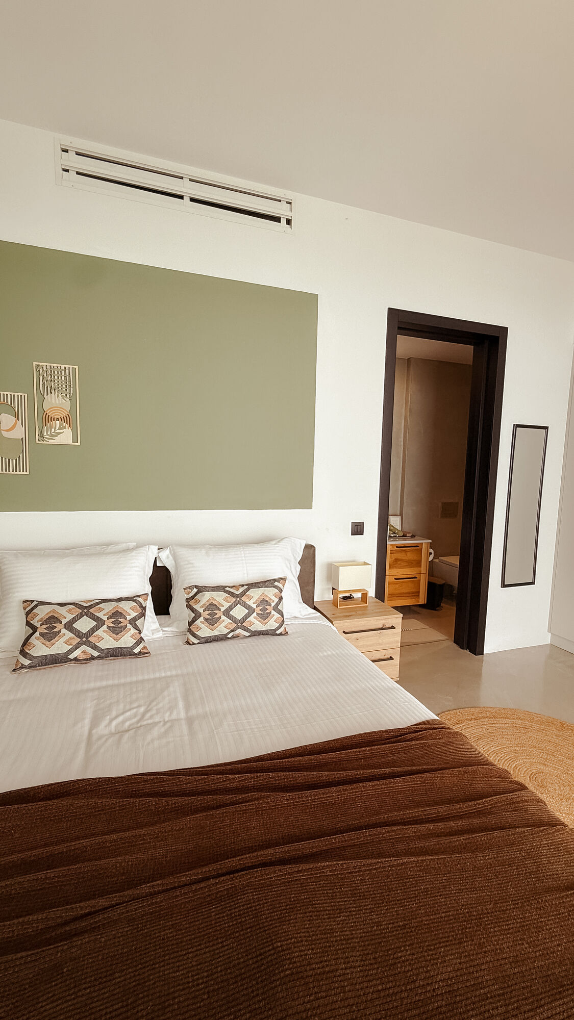 Bedroom one with green accent wall